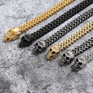 Detailed close-up of punk skull bracelets in gold, black, and silver steel finishes
