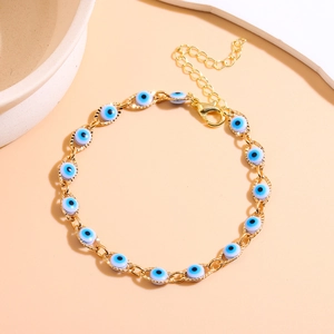 Close-up of golden Evil Eye bracelet with blue beads, lobster clasp and extension chain