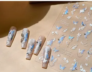Detailed view of frozen blue butterfly nail art stickers with embossed pearl chain designs
