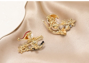 Detailed back view of a Christmas brooch with safety pin clasp on champagne satin cloth