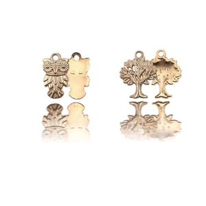 Golden owl and tree of life charms with hanging loops and elegant reflections