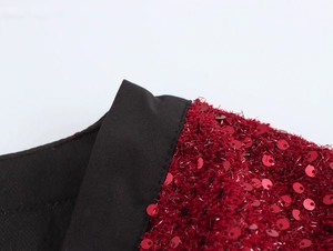 Dettaglio della giacca in tweed con paillettes lucide e fili dorati sullo scollo