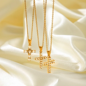 Elegant gold-tone cross pendant necklace featuring inlaid sparkling zircon stones