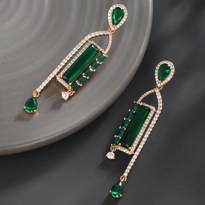 Detailed macro view of vintage emerald drop earrings with sparkling cubic zirconia pavé