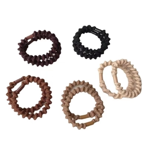 Elastic ponytail hair ties in assorted earth tones like black and brown on white back