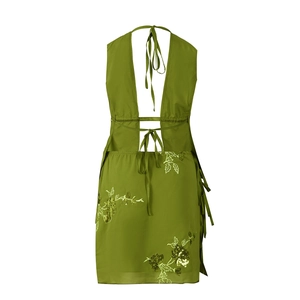 Detail of olive green halter dress featuring intricate floral embroidery and sequins