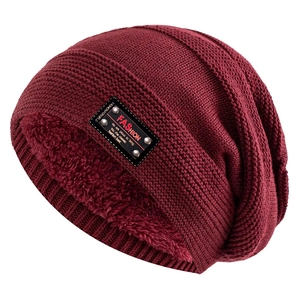 Detail of burgundy knitted beanie showing thick fleece lining and leather fashion patch