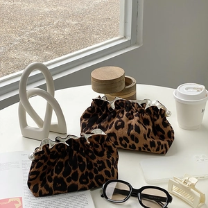 Detailed close-up of leopard print velvet makeup bags with elegant pearl zipper charms