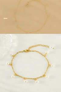Close-up of 18K gold-plated stainless steel anklet with elegant hanging white pearls