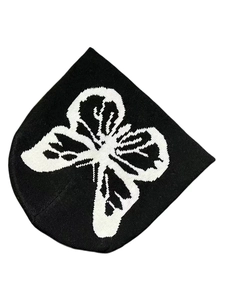 Close-up of black knit beanie featuring white butterfly jacquard texture for winter
