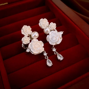 Detail of rose drop earrings with resin flowers, white pearls and teardrop zircons