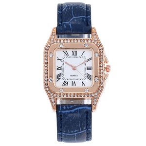 Detail of rose gold square watch case with crystal bezel and Roman numeral white dial