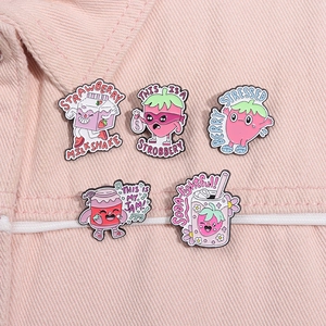 Close-up of five cute strawberry enamel pins on pink denim jacket pocket with punny text