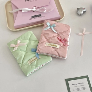 Quilted passport holder set with decorative bows in pastel pink and light green