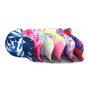 Fan-shaped display of six colorful tie-dye baseball caps with curved brims on white background