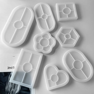 Flat lay of multiple geometric white silicone molds including heart, hexagon, and oval shapes