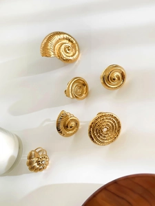 Macro shot of gold stainless steel shell ring set featuring delicate inlaid rhinestones