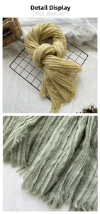 Detail view of textured pleated cotton linen scarf with soft fringe and tassels