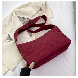 Close-up detail of burgundy corduroy quilted tote bag with soft texture and rhombus pattern