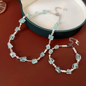 Dettaglio del set collana e bracciale con pietre azzurre irregolari in astuccio regalo