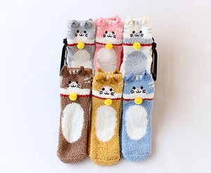 Detail of six pairs of fluffy coral fleece socks with cat ears and small bells in soft pastel colors