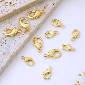 Flat lay of multiple shiny 18K gold plated lobster clasps for DIY jewelry making