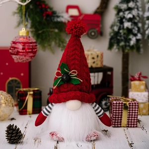 Lighted Christmas gnome doll with red knitted hat and plush beard on festive background