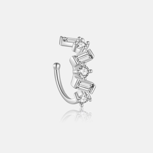 Macro shot of silver cuff earring with baguette and round cut zirconia stones