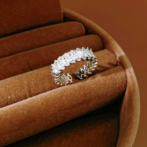 Close-up of marquise-cut cubic zirconia stones on a silver-toned eternity band ring