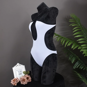 Detail view of monochrome black and white one-piece swimsuit on a mannequin display