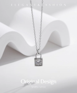 Macro detail of silver lock pendant with round moissanite stone on an elegant necklace