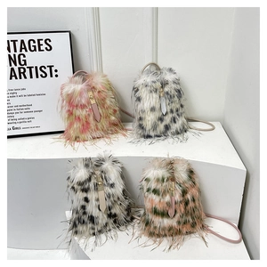Macro shot of faux fur bucket bags featuring drawstring closure and metal hardware