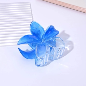 Detailed close-up of blue gradient transparent flower hair claw clip with glossy acrylic finish