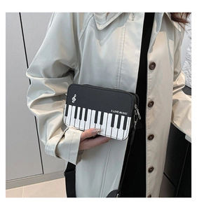 Detail of piano keyboard pattern crossbody bag with I LOVE MUSIC print and music note