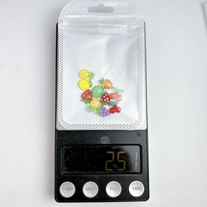 Detailed view of 2.51g assorted resin fruit nail art charms in a transparent bag