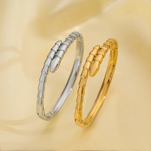 Luxury serpenti style open cuff bracelets in gold and silver finish on silk fabric