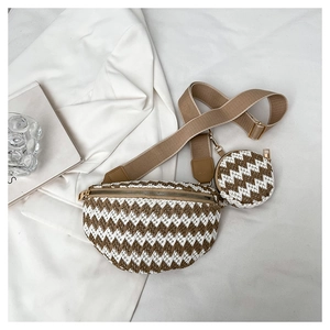Detail of woven brown and white fanny pack with round coin purse and wide strap