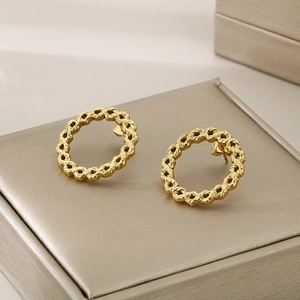 Minimalist 18K gold plated stainless steel twisted oval hoop earrings on jewelry box