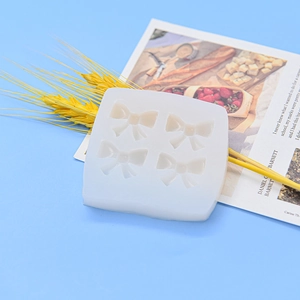 White silicone mold with four bow shapes for DIY fondant, chocolate and cake decoration