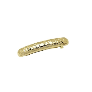 Minimalist golden metal barrette with unique hammered texture on a clean white background