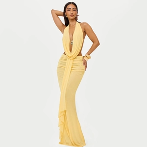 Detail view of yellow V-neck halter dress with elegant pleated design and draped hemline