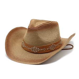 Detail of western woven straw hat with studded leather band and adjustable chin strap