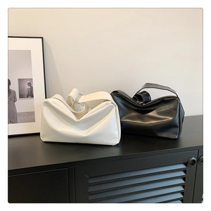 Minimalist large capacity soft leather tote bags in black and white displayed on a shelf