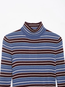 Detailed view of high neck knit sweater featuring multi-colored horizontal stripes