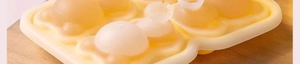 Detailed macro view of a cream silicone mold for creating sphere-shaped ice balls