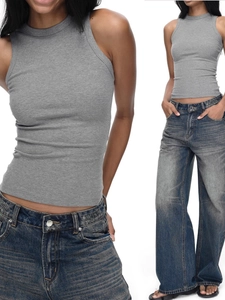 Slim fit grey ribbed racerback tank top paired with washed denim jeans on white background