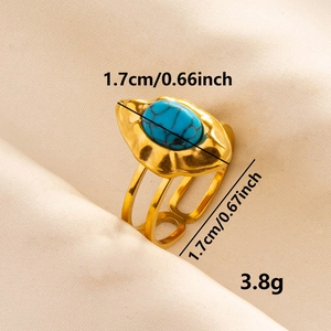 Adjustable golden stainless steel ring featuring an oval blue turquoise stone on fabric