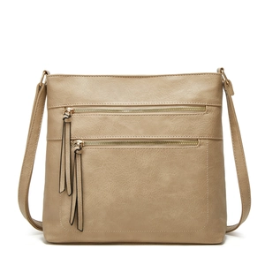 Detail of khaki tote bag with dual front zippers and stylish leather tassels