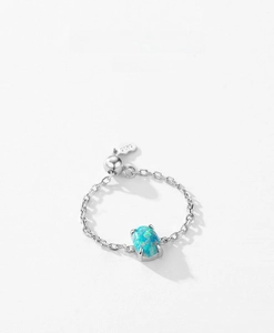 Detailed macro view of S925 sterling silver chain ring with blue oval opal stone setting