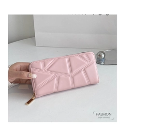 Detail of light pink PU leather long wallet featuring geometric quilted stitching and zipper
